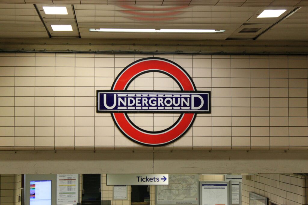 Close-up of the classic London Underground sign at a subway station entrance.